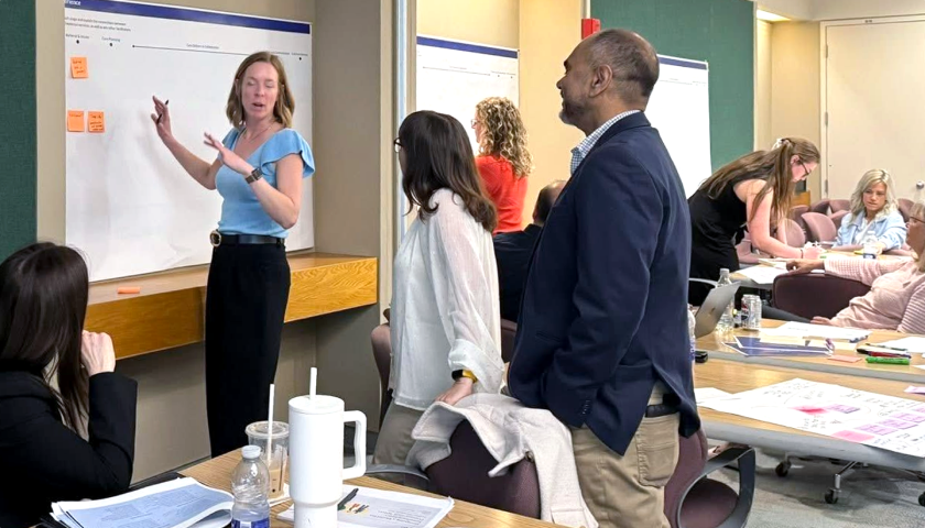 An image of various healthcare providers having a discussion during a workshop.